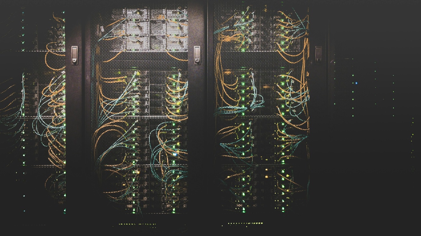 Data center server racks with structured network cabling representing CMMC-aligned security controls