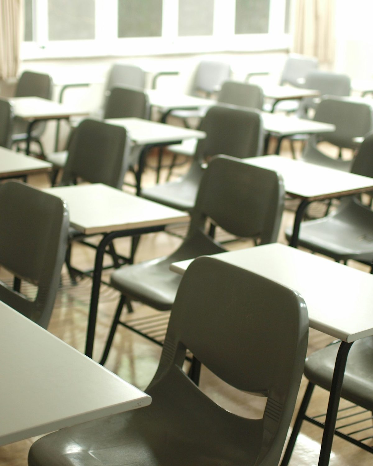 Rows of desks in an empty classroom