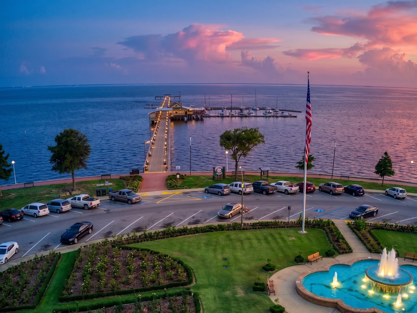 The Fairhope, Alabama municipal pier and bayfront gardens at sunset