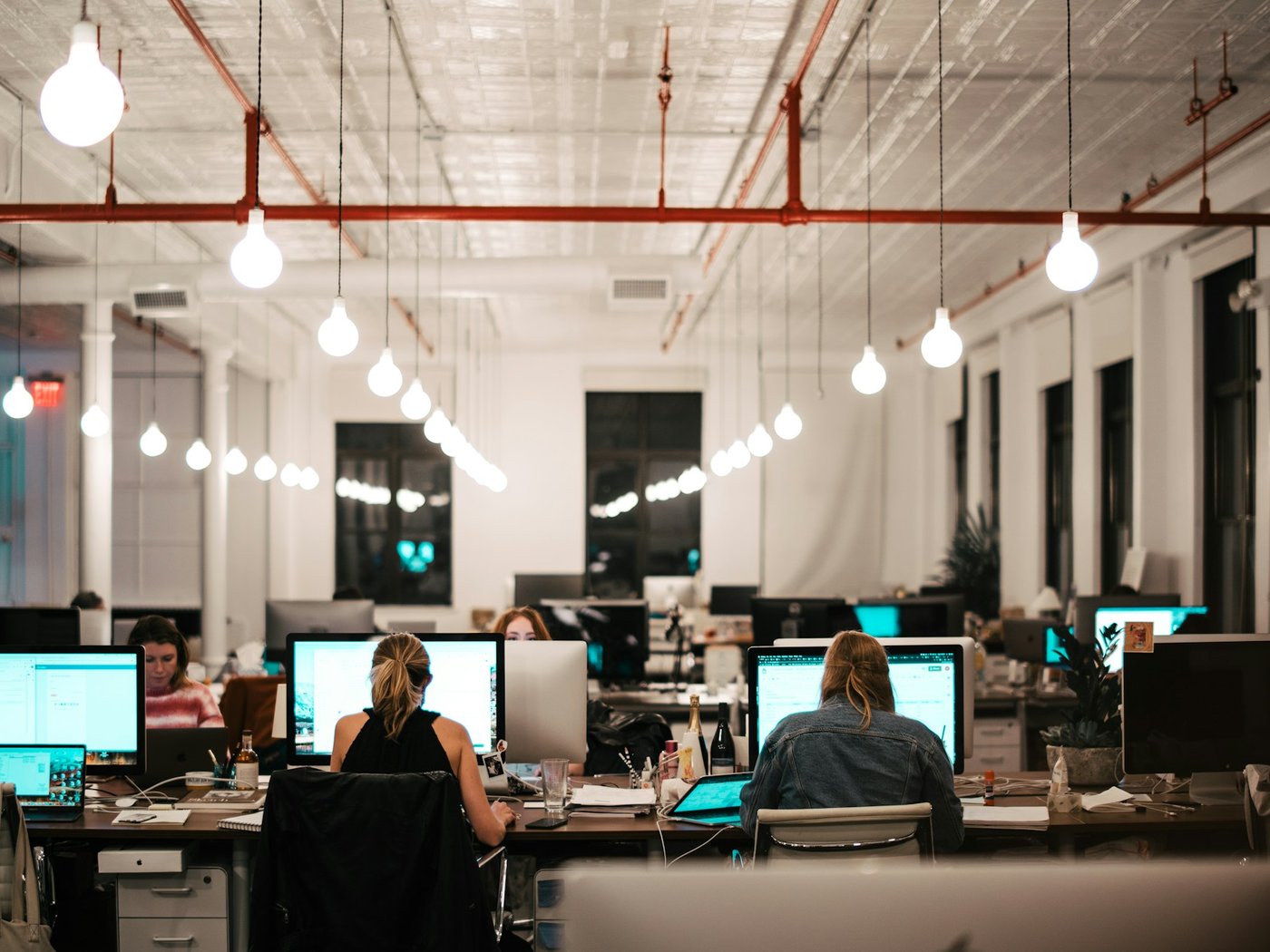 Team working at computer workstations in an open-plan office