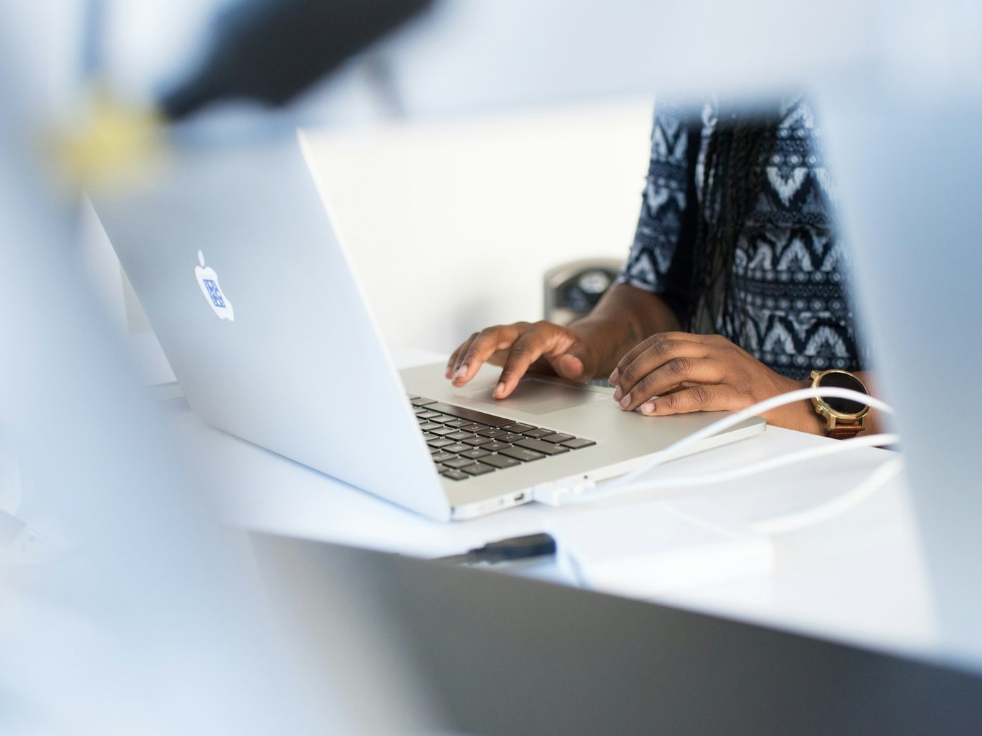 A small-business owner working on a laptop at a desk